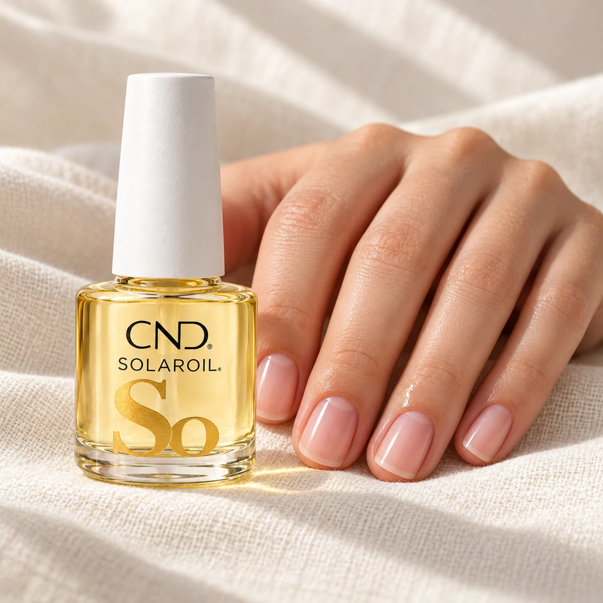 AI illustration of CND SolarOil beside a hand with short natural pink nails
