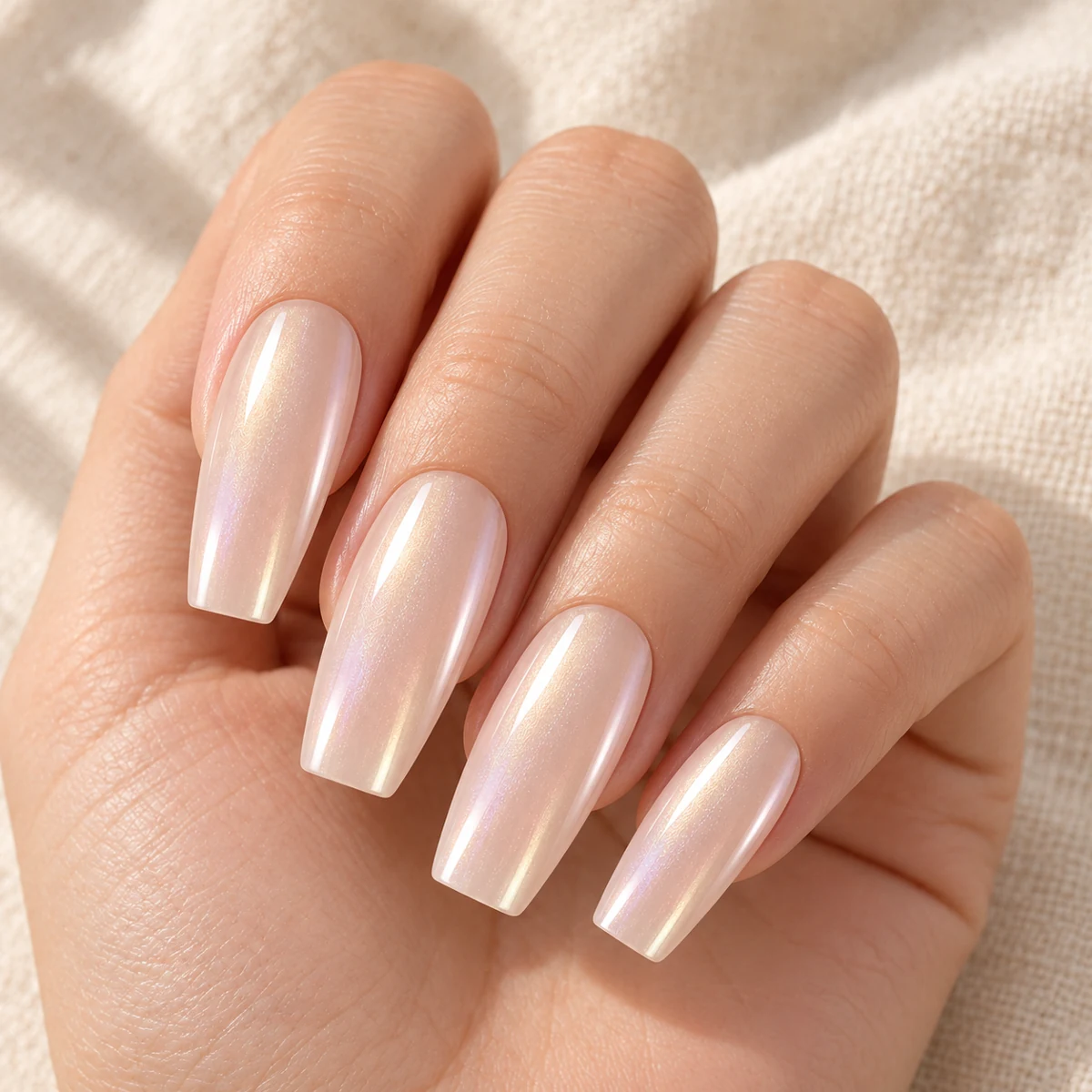 AI illustration of long coffin nails with beige-pink pearl shimmer on a relaxed hand